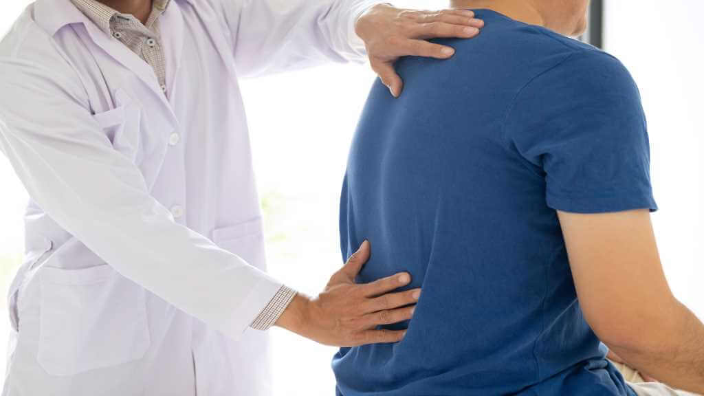 Doctor examining back pain in patient 1 1